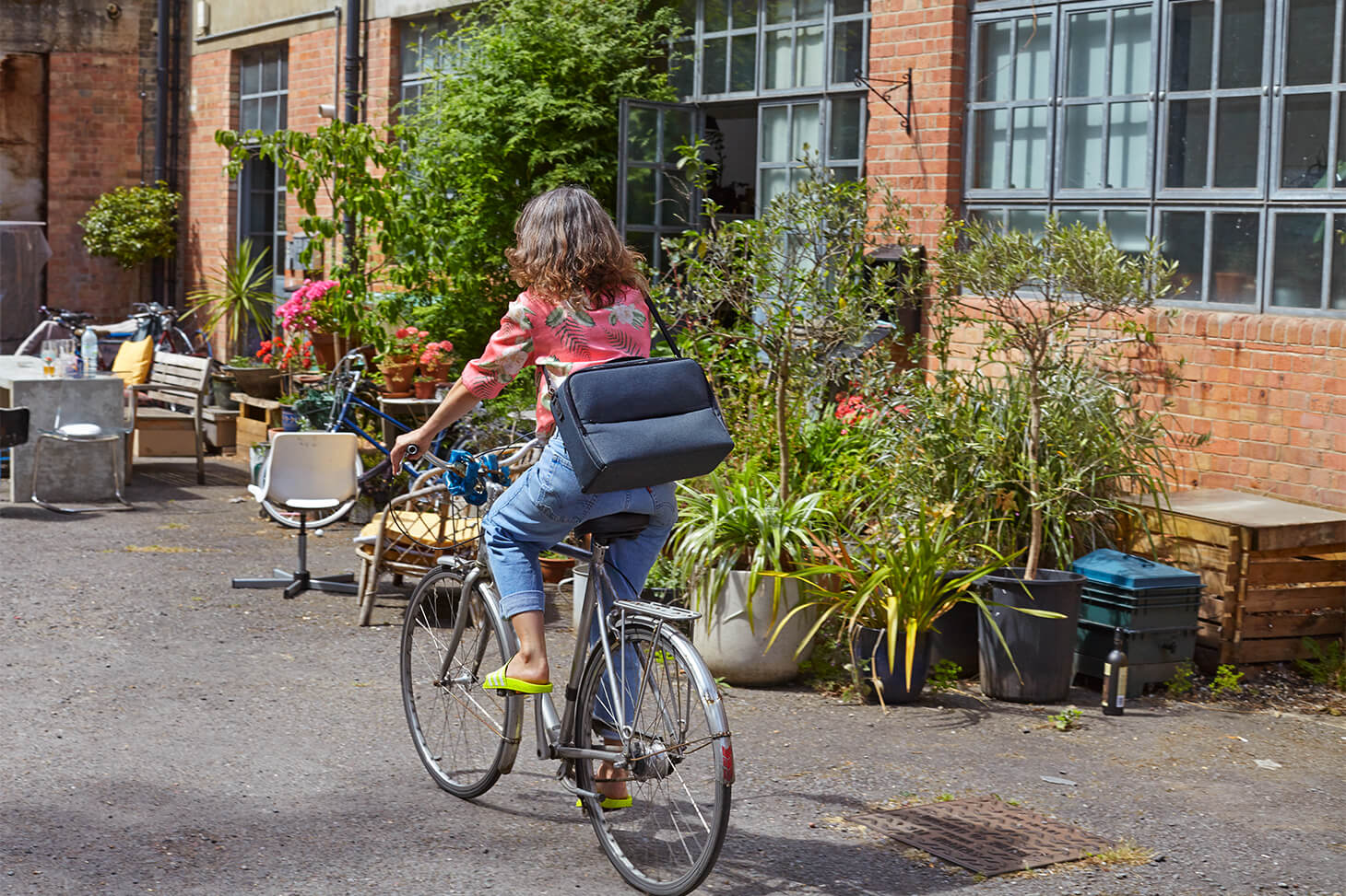 A woman cycles to work on a sunny day