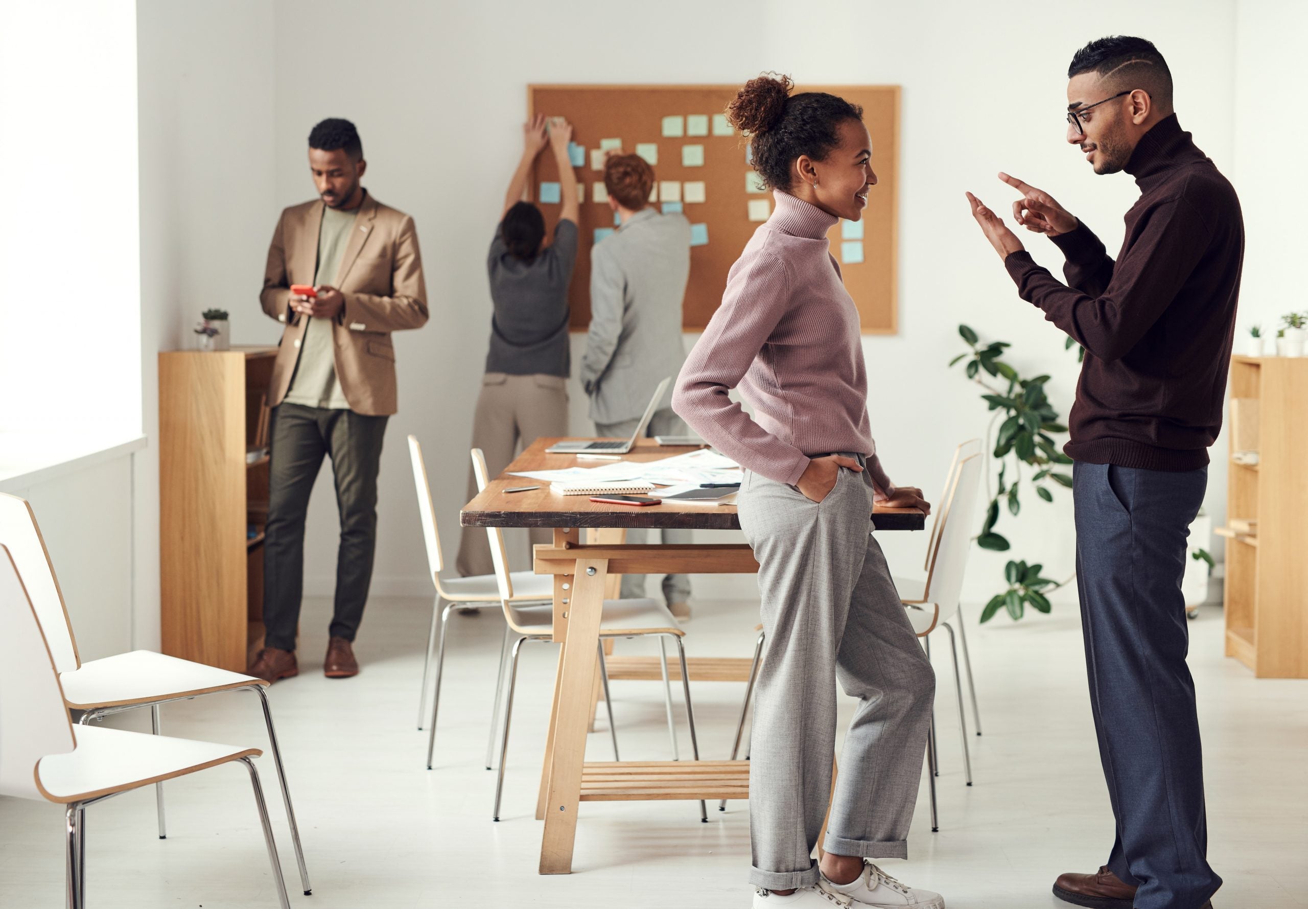 A group of workers collaborate in a co-working space