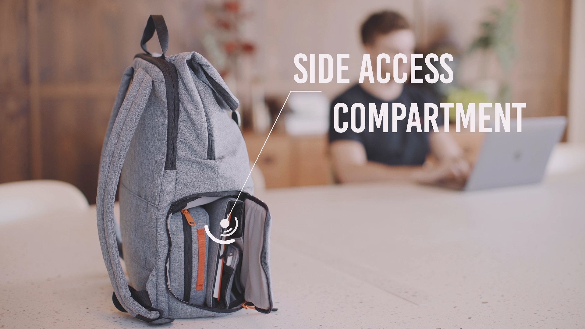 A Hotbox Shuttle backpack sits on a desk in a co-working space